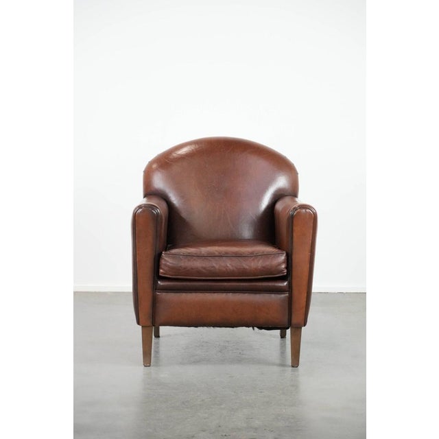 This beautifully shaped armchair is crafted from sheepskin and, thanks to its timeless design, fits into virtually any...