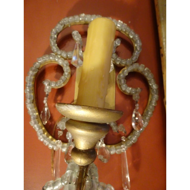 Pair of Italian beaded crystal sconces . Back gold metal plate to facilitate installation. one arm. US wired. Gilt wood...