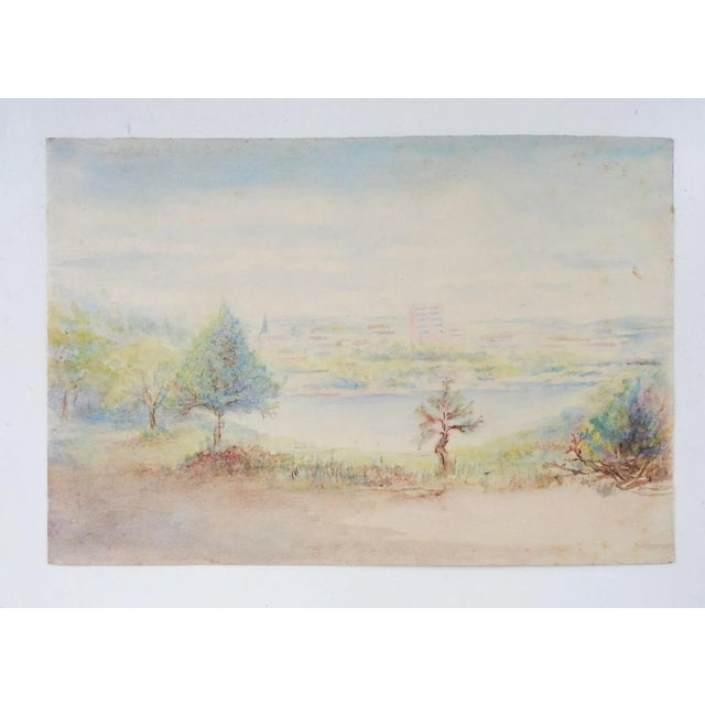 Antique circa 1910 watercolor on paper landscape with river and city in background. Unsigned. Unframed, age toning.