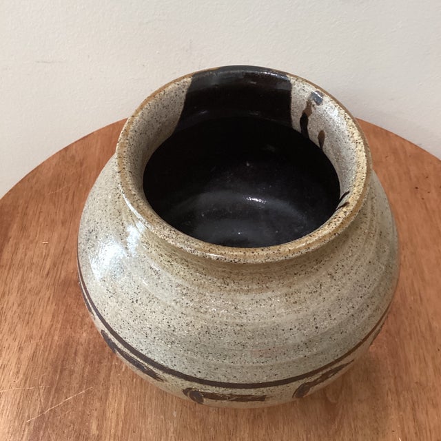 This vintage stoneware pottery vase features a unique tan/brown speckled glaze with a moriage style design, giving it a...