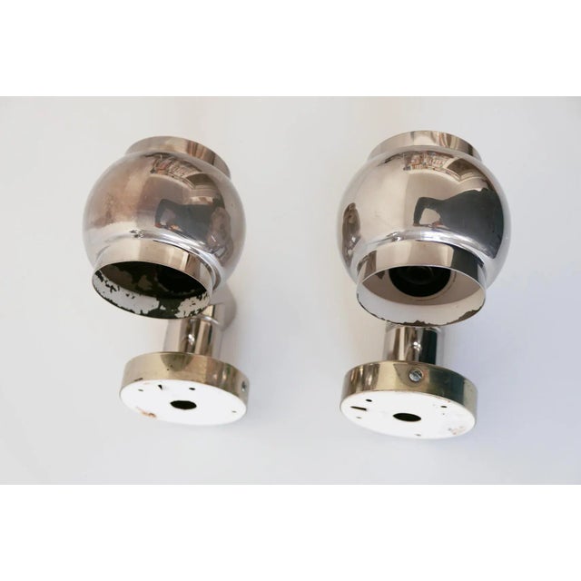 - A set of two elegant Mid-Century sconces with rotating shades - Manufactured in Germany circa 1960 - Made of nickel-...