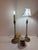 What a delicate pair of Italian table lamps made to resemble golden candle sticks. They are mid-century modern lamps made...