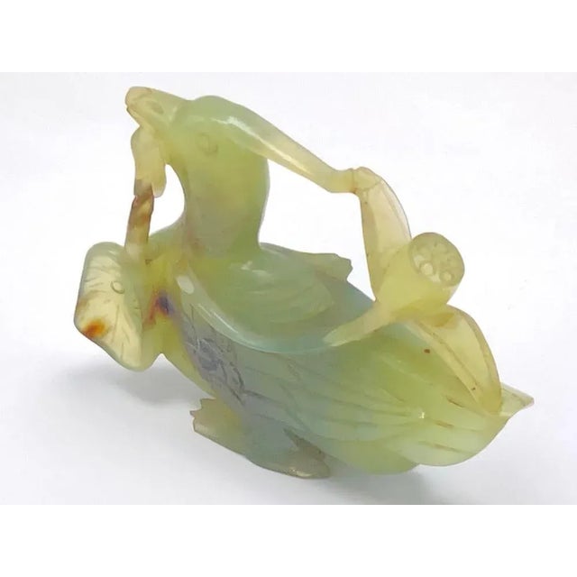 This bird is in Jade. It has been made in China during the 20th Century. The color is green.