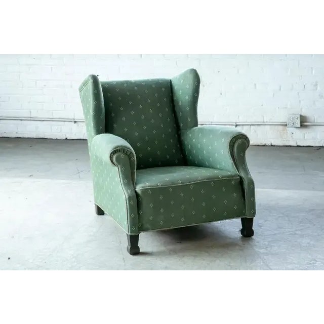 Superbly stylish oversized club chair and based on style, construction and condition probably made around 1950. The style...