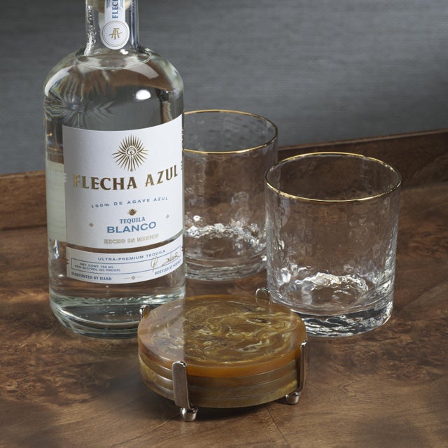 Protect your surfaces with style using the Spiga Resin Coasters. These colorful, round resin coasters are stored in a...