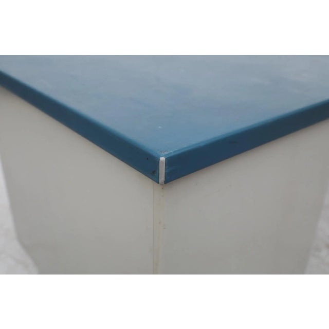 Gispen 'Kleuro' line industrial office desk with a blue linoleum writing surface, three blue-enameled drawer fronts, and a...