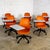 Wonderful Early 21st Century Modern Steelcase orange Node Task Chairs with a white work surface, black metal shaft, &...