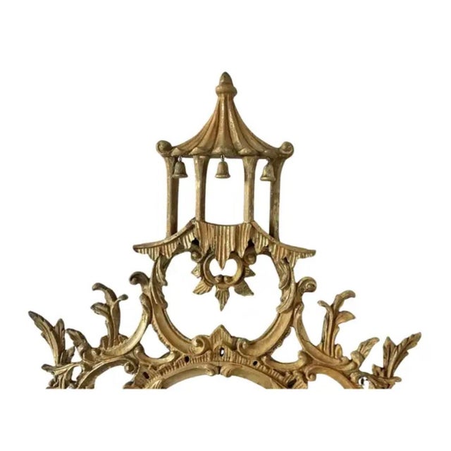 20th Century Chinoiserie Style Oval Mirror. Mirror features an oval mirror plate framed by an intricately carved giltwood...