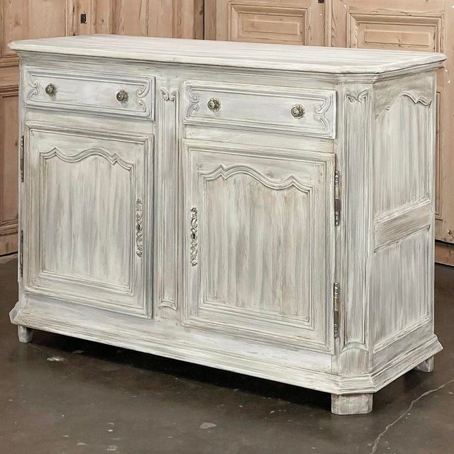 19th Century Country French Whitewashed Oak Buffet is a study in understated elegance! The spacious top features fine...
