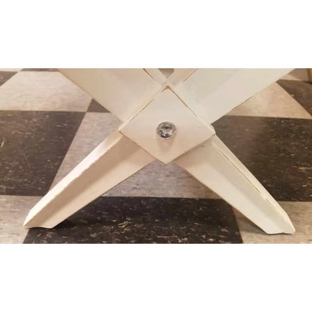 Mid-century 2 tier side-table recently painted in a matte finish white. Soft distressing on the edges and accented with a...