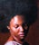 The painting "Warmth" presents a serene portrait of a woman, her head slightly bowed, exuding a sense of introspection and...