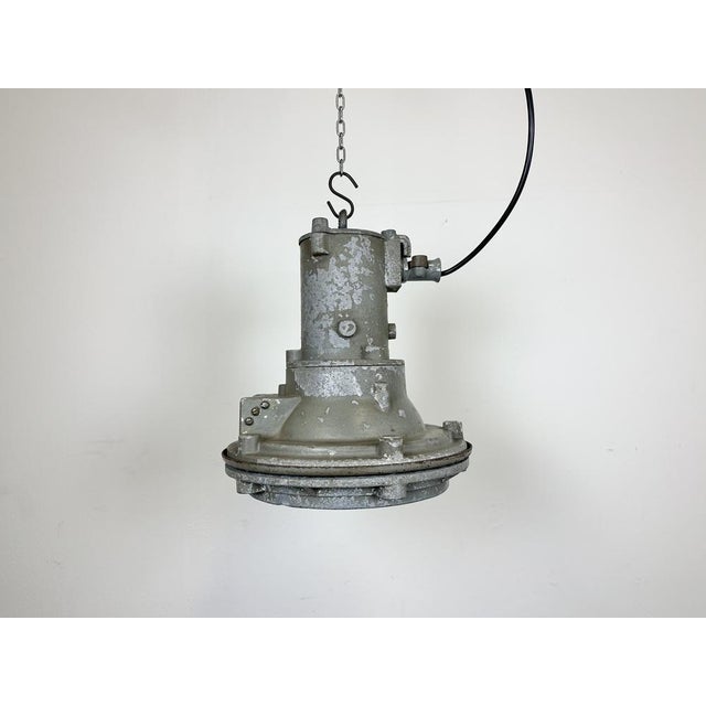 Industrial factory hanging lamp made in former Czechoslovakia during the 1960s. It features a cast aluminium body and a...