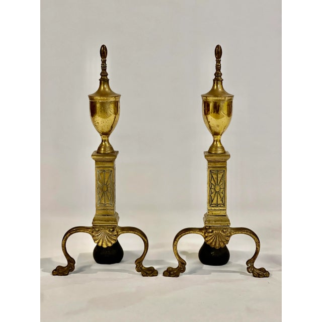 Antique brass fireplace andirons by Bennett Co., c. 1920's. Elegant andirons Chippendale in style with a nod to Art Deco...