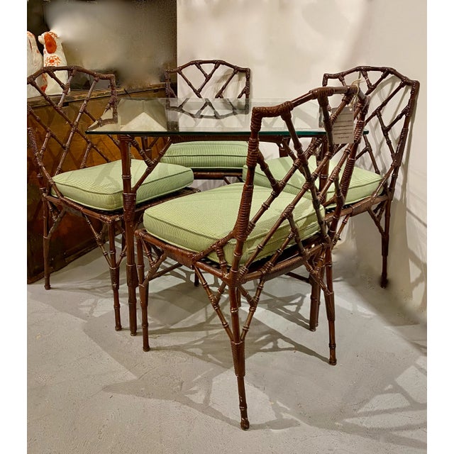 This is an unusual set of 4 Chinese Chippendale cast aluminum side chairs in the Chinese Chippendale style together with a...