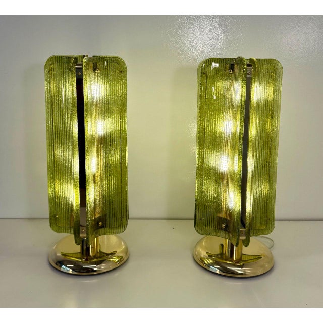 Elegant pair of table lamps produced in the early 2000s, featuring a sculptural design composed of curved transparent...