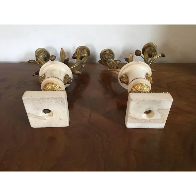 Antique pair 18th century French Louis XVI fire gilt bronze and white marble urn form candelabra. In the form of a...