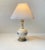 A japanese inspired gourd long-neck ceramic table light with blue floral decor made by hand. The light features a brass...