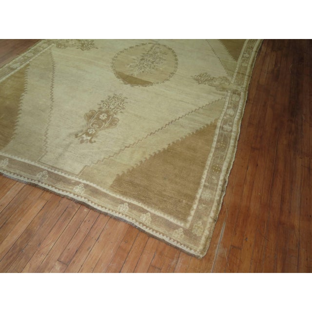 Turkish Kars in browns and khaki with an elegant open field central medallion design. 6'7'' x 10'2''