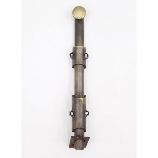 Vintage surface mount slide door bolt made of brass with a mixed brass and black finish. The catch is made of cast iron....