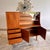 An exceptional vintage cocktail cabinet by Jentique Furniture Ltd., executed in richly figured teak and showcasing the...