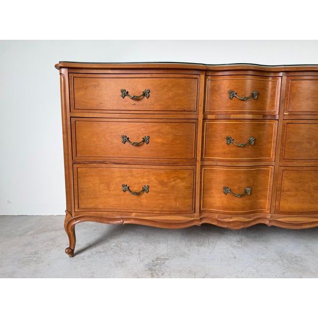 Elegant Drexel Touraine French Provincial Louis XV style nine drawer dresser featuring a beautifully shaped serpentine...