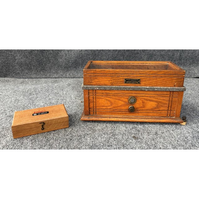 This antique Henry Troemner Apothecary Scale and Weights No. 190B features a handsome oak case with glass viewing lid and...