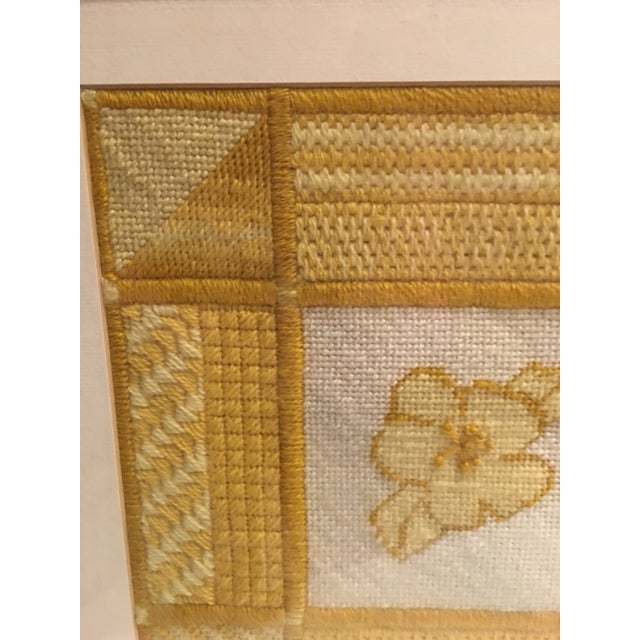 1970’s retro yellow and white framed needlepoint sampler in brushed gold frame. Eight different stitches under glass,...