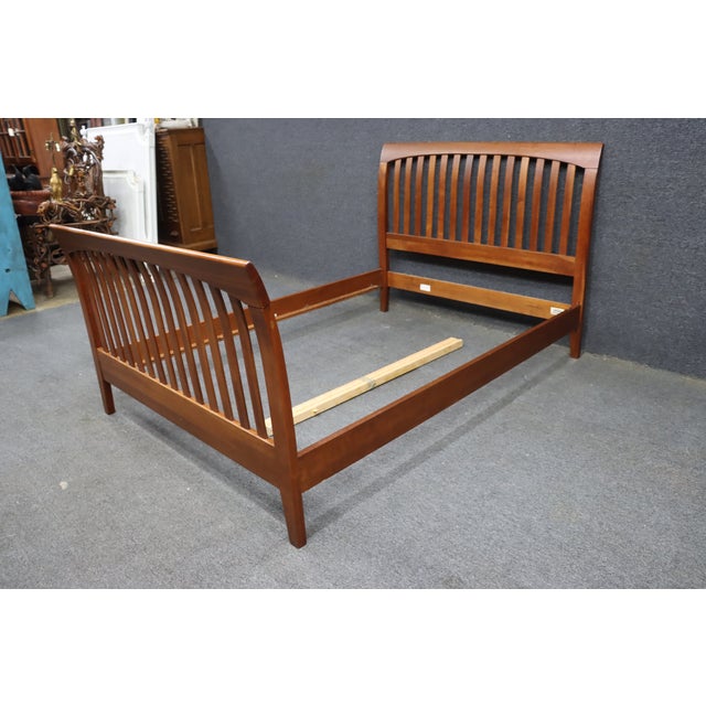 Ethan Allen bed from the American Impressions collection, featuring a warm cherry-toned finish and slatted spindle...