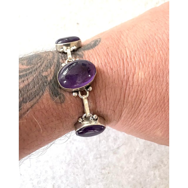 Lovely amethyst and sterling silver bracelet. Includes five oval shaped amethyst stones set in sterling silver. Inclusive...