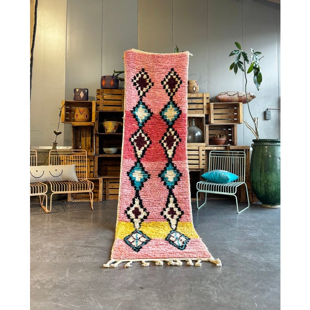 This Moroccan Boujad runner rug is an authentic handwoven piece from the Middle Atlas region, characterized by its...