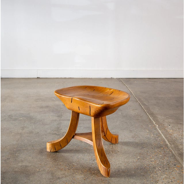 Solid ambrosia maple featuring beetle and worm holes and tunnels throughout. This stool with a thick hand carved seat...