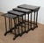 Set of four leg tables, built -in with each other, of increasing size. Black lacquered, their top is decorated with...