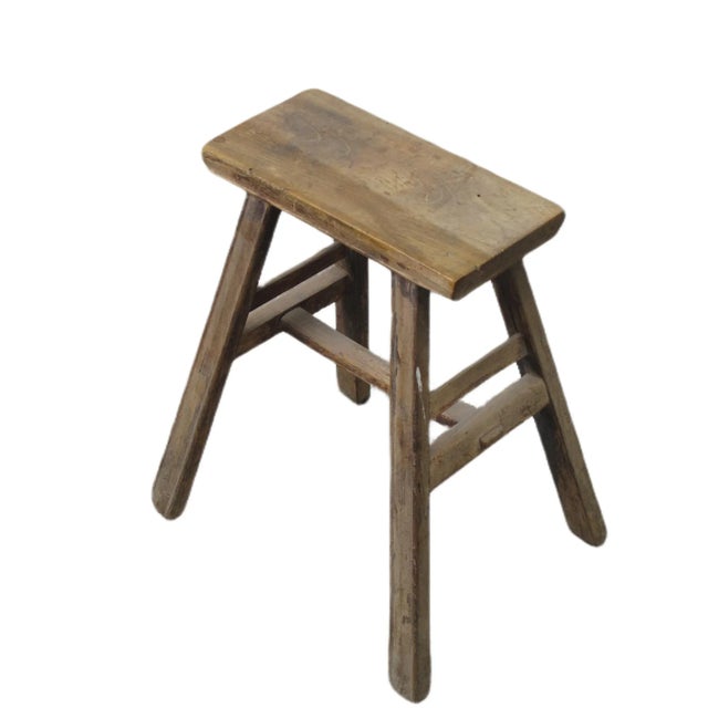This small stool is made of solid elm and constructed mortise and tenon joinery. Solid structure. It shows age proper...