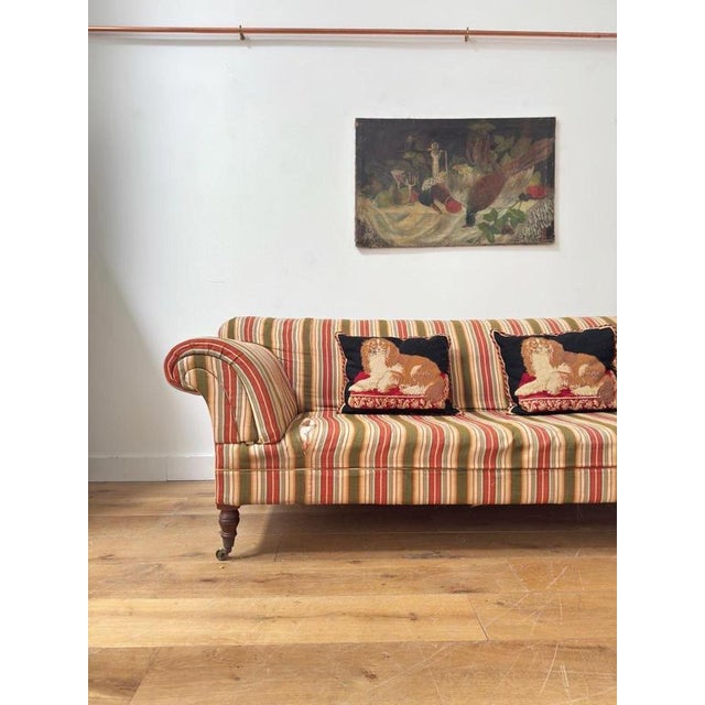 A beautifully English scrolling country house deep sofa upholstered in the most fabulous ticking stripe. Sadly in need of...