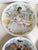 Here is a set of four vintage 1970s French Limoges porcelain plates from D’Arceau-Limoges’ “Les Femmes du Siècle” (Women...