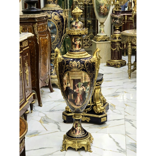 Elegant black porcelain vase featuring rich gold leaf detailing over a deep dark background, creating a bold and refined...