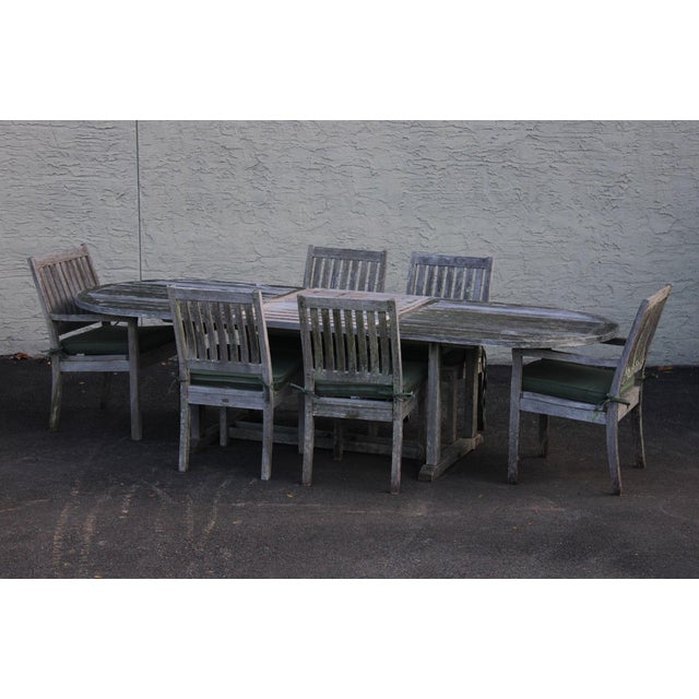 High Quality Teak Outdoor Dining Set By Gloster Featuring A Large Oval Dining Table With A Extension Leaf And Six Matching...