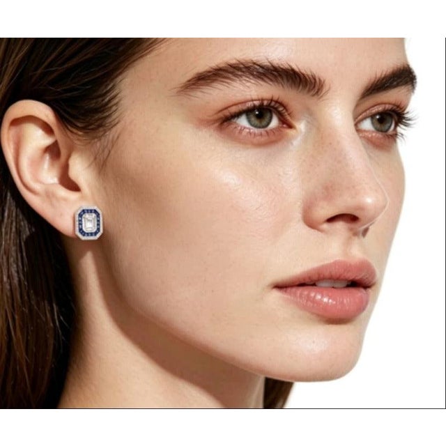 This gorgeous 18K white gold pair stud earrings features: Sapphires: Natural round sapphires totaling 0.9 carats Diamonds:...