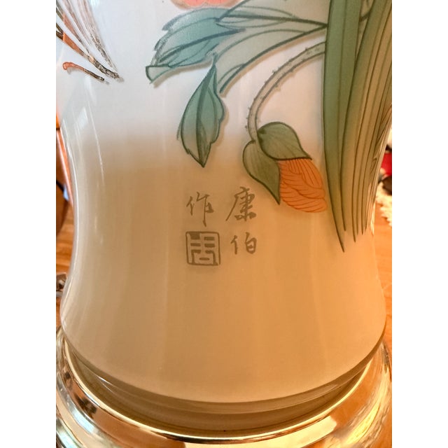 Large hand-painted lamp. Cream/tan background with flowers, grass and a butterfly. Does not come with a lampshade. This...