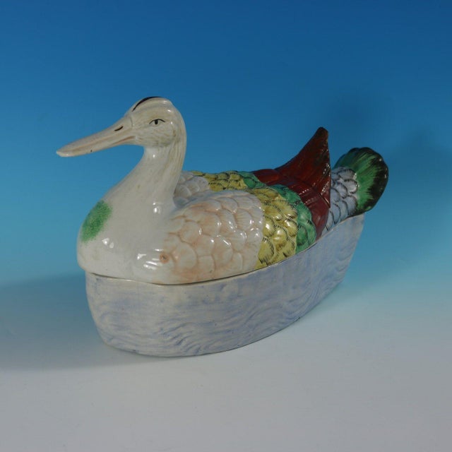 Staffordshire Pottery tureen with cover which features a duck forming the lid, sitting on a base molded with a rippling...