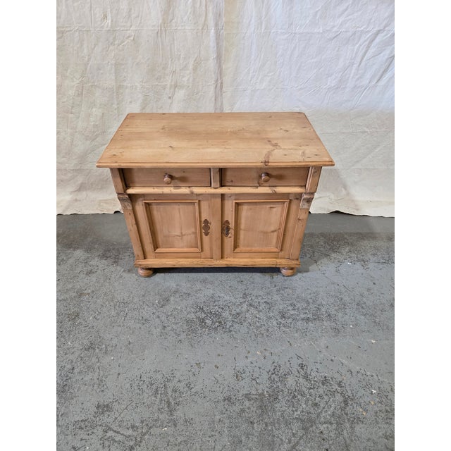Late 19th-century German provincial cabinet crafted from solid pine with a warm naturally aged finish and beautiful rustic...