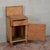 A vintage Art Deco nightstand dating from the 1930s, characterized by a compact silhouette with an elegant, contoured back...