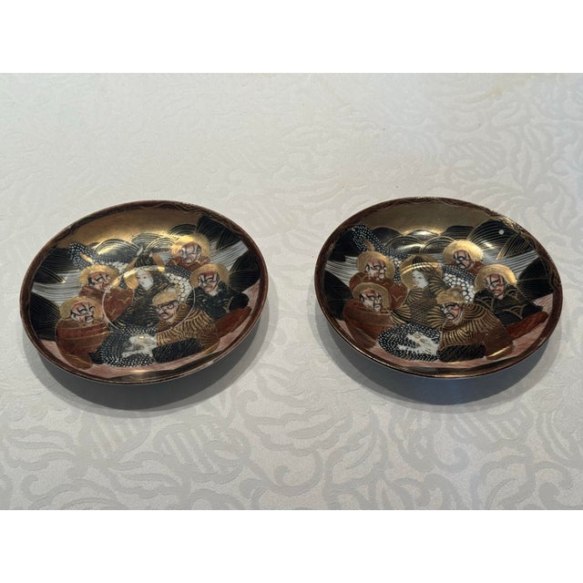 These plates depict Rakan and dragon subject, which is characteristic of Japanese Satsuma in the Meiji period. The plates...