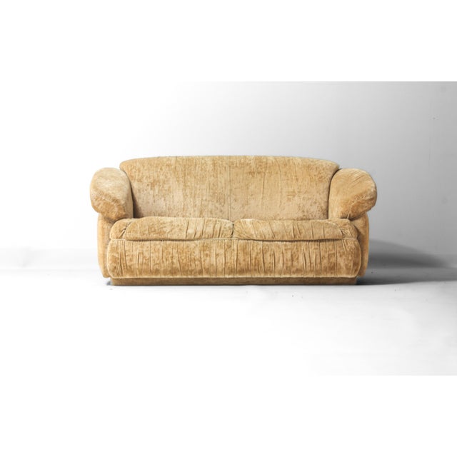 Compact, low-profile Italian 2-seater with a continuous, rounded silhouette. The armrests are thick and slightly sloped...