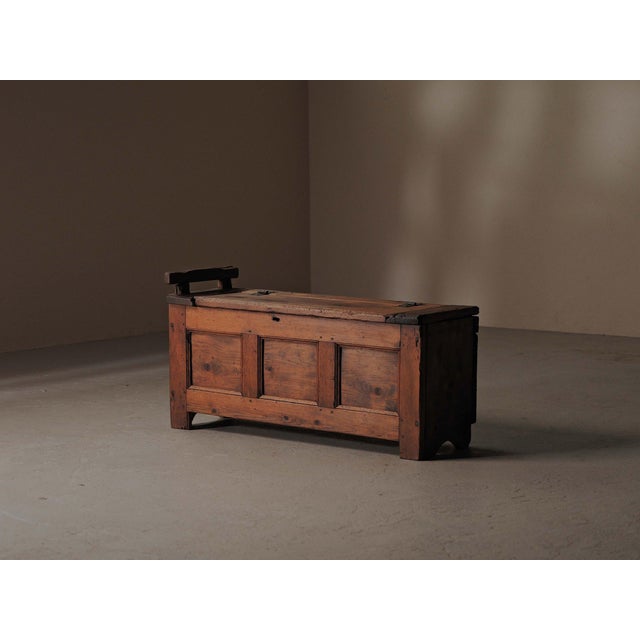 Solid pine storage bench, fine example of 19th-century folk furniture from the Auvergne region. Combining seating and...