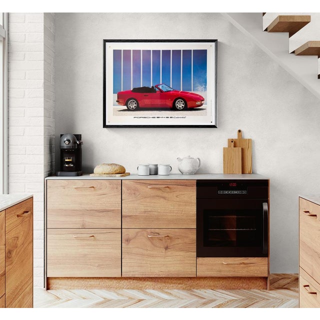 The Piece This original vintage poster presents the Porsche 944 S2 Cabriolet in a vibrant profile view. The bright red...