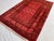 A vintage Afghan Ersari Turkmen rug in an unusually soft, rose-tinged colorway — rows of small quartered güls with ivory...