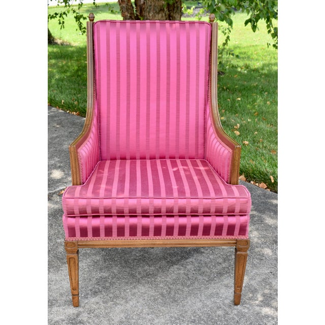 Vintage (1960's) Bergere Armchair has a Hollywood Regency Style. The Frame is Wood. Fruitwood. Carved. Pink Magenta Stripe...