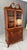 This 1960s vintage mahogany bookcase features elegant Chippendale-inspired lines, arched fretwork glass doors, and a...