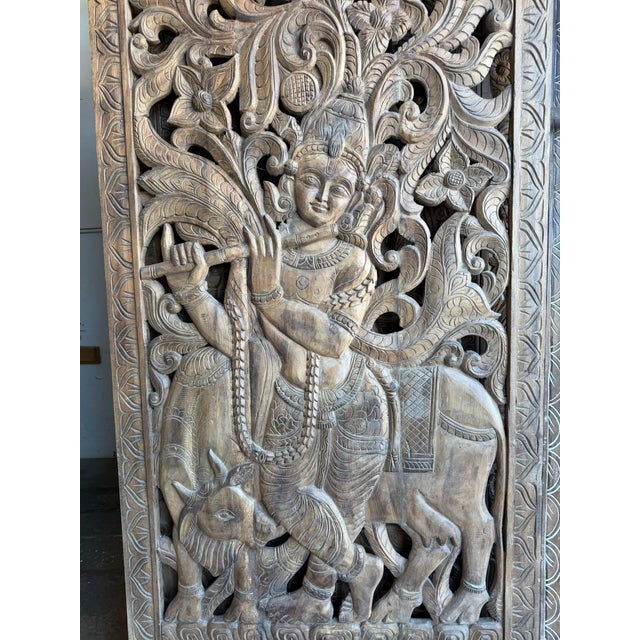 Celebrate the beauty of traditional Indian craftsmanship with this antique hand-carved solid wood Krishna barn door....